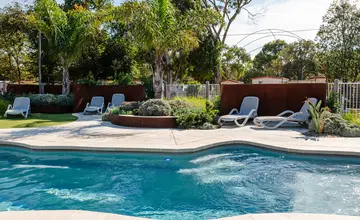 Lagoon style swimming pool surrounded by landscaped gardens at Geelong Holiday Park.